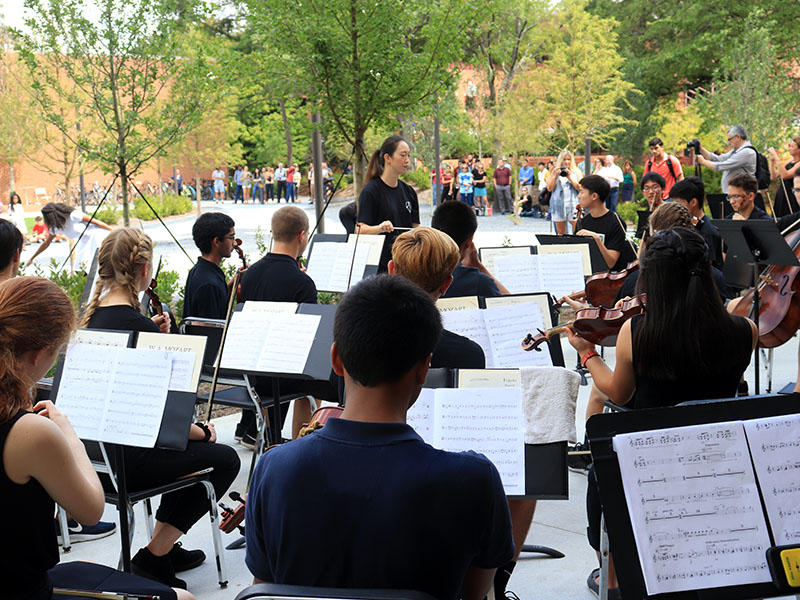 The Symphony Orchestra performing in an outdoor concert.