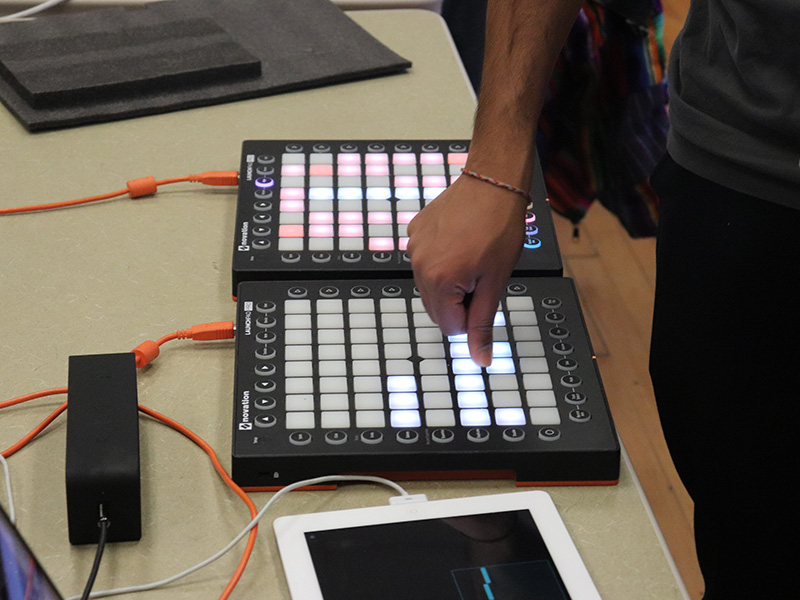 A student using mixing equipment in a class demo.