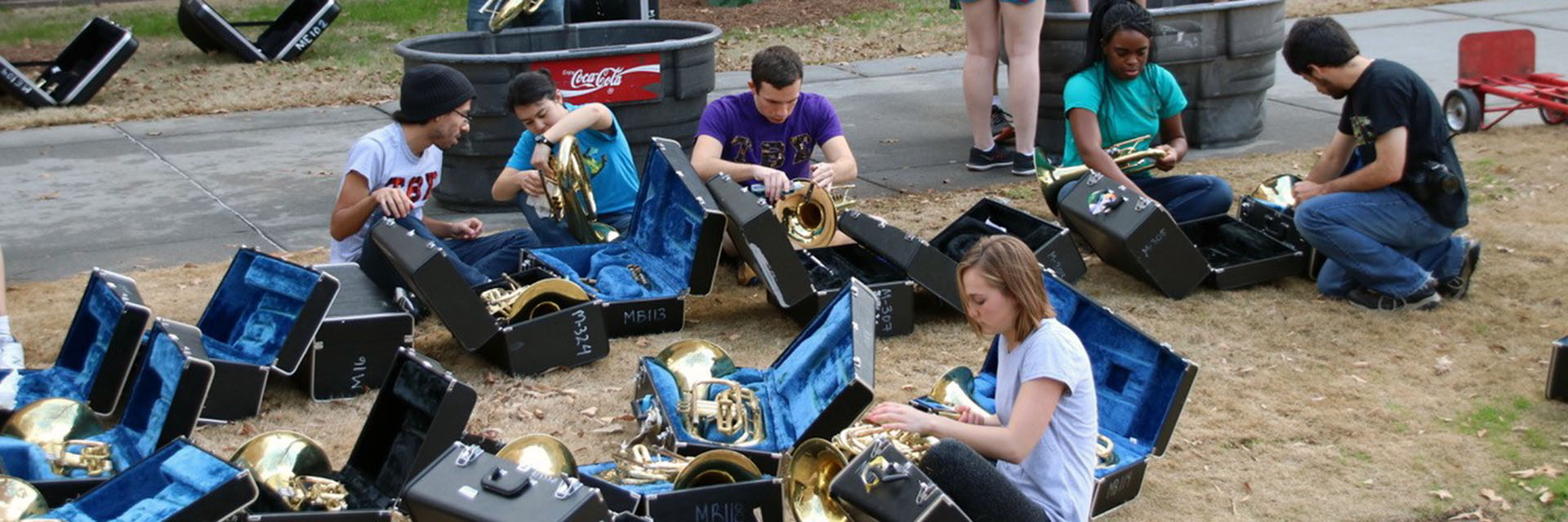 A group of students maintaining and cleaning instruments.