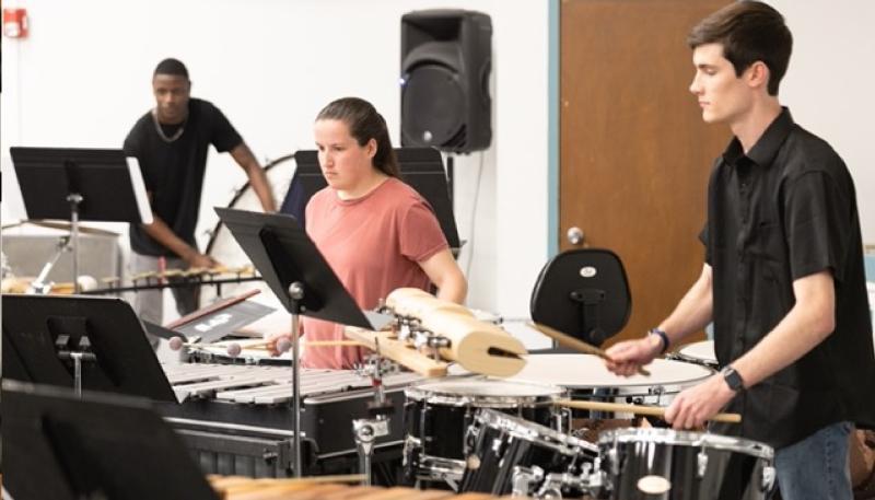 Two members of the percussion ensemble play marimbas